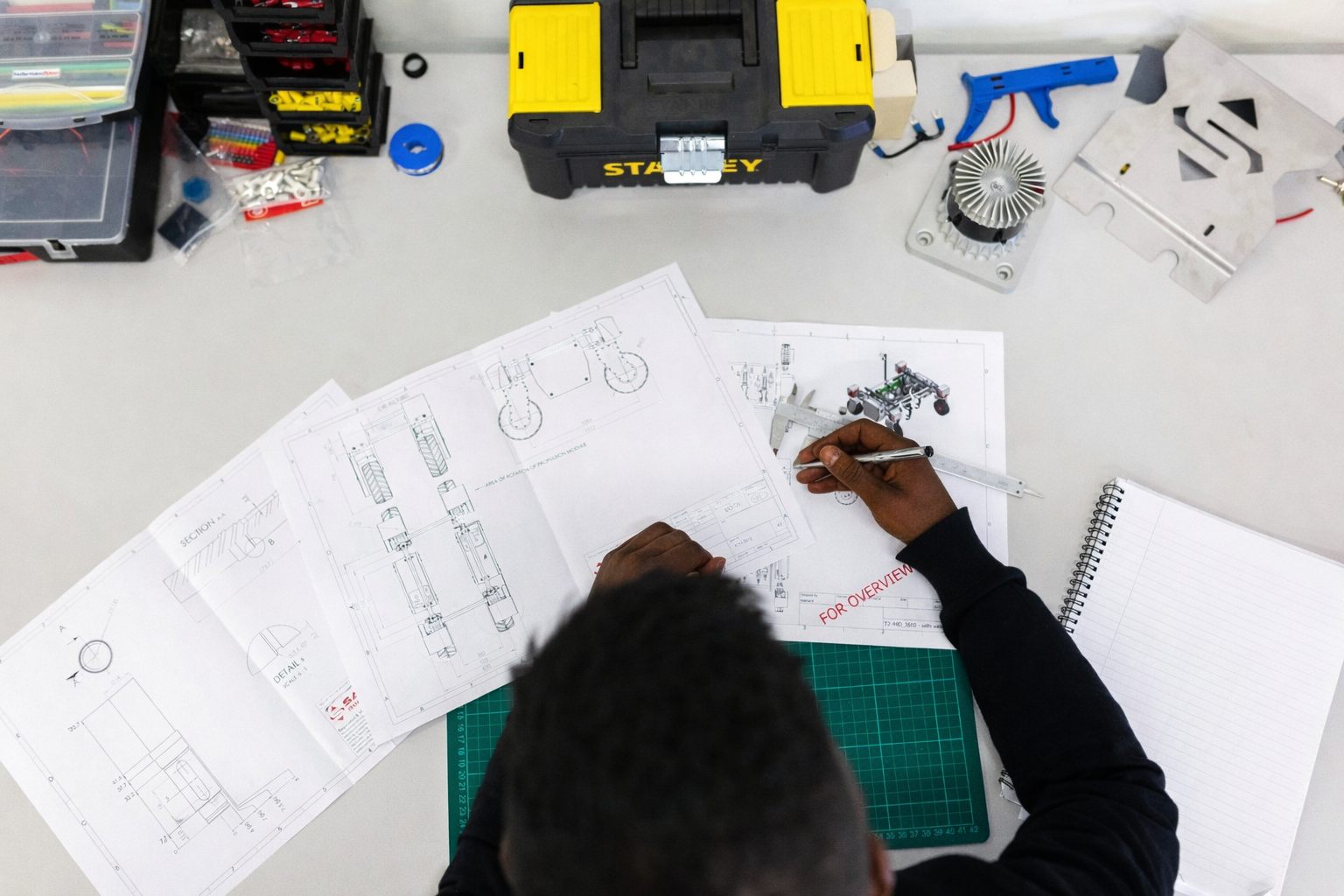 Engineering team reviewing technical drawings