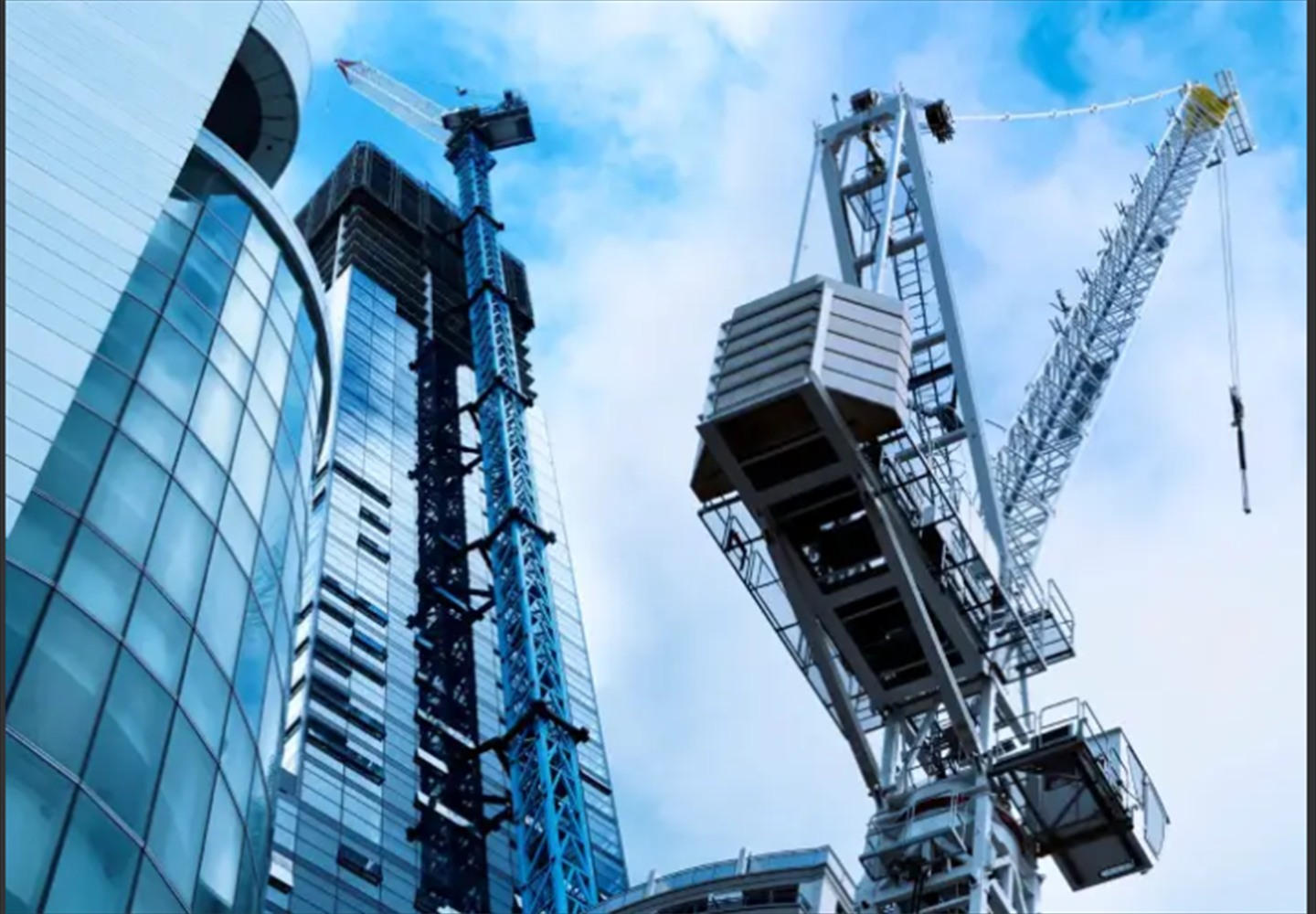 Construction site with multiple cranes and building development